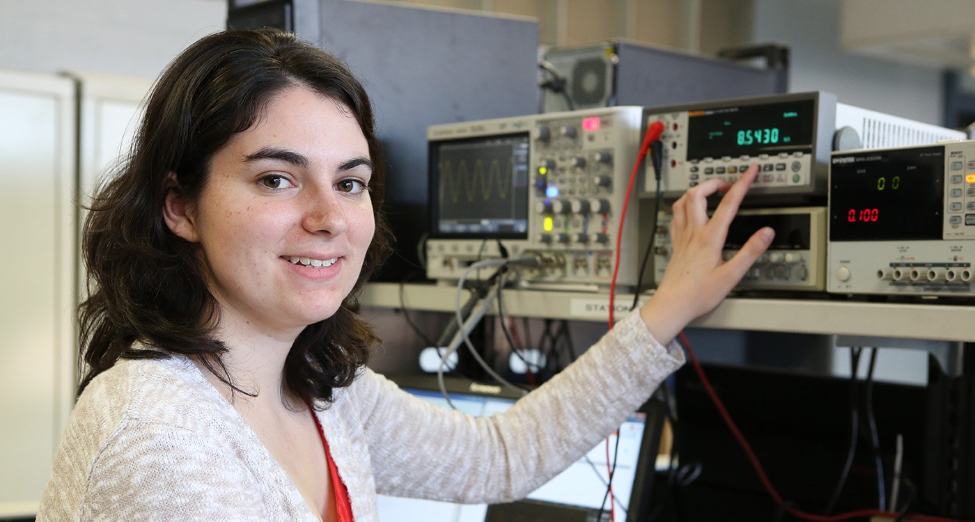 ECE student, Erin Graceffa poses with electrical equipment.