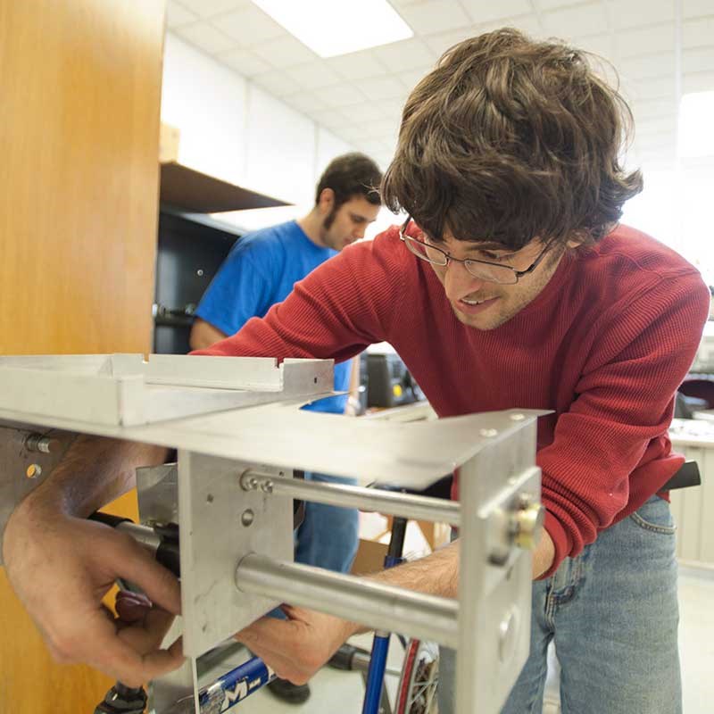 Student builds with equipment in a UMass Lowell electrical and computer engineering lab