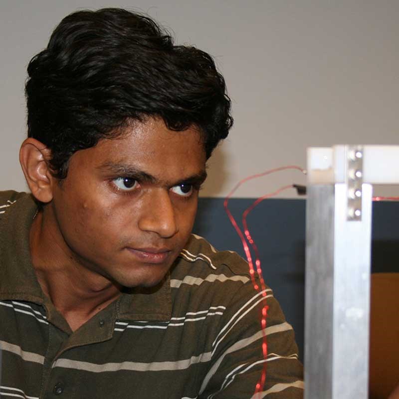 A student looks at wires in an electrical and computer engineering lab at UMass Lowell