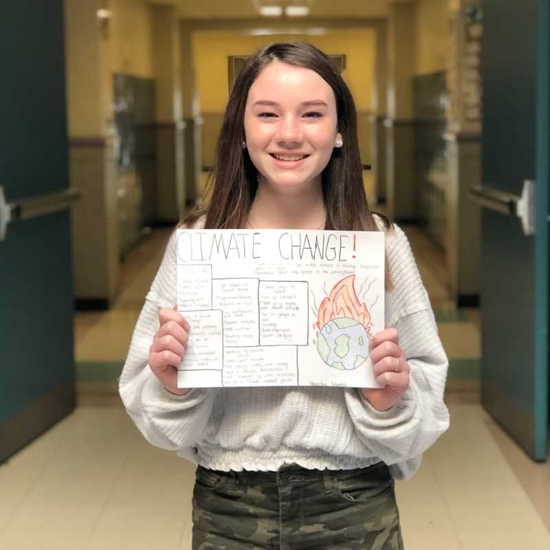 Student holding climate change sign