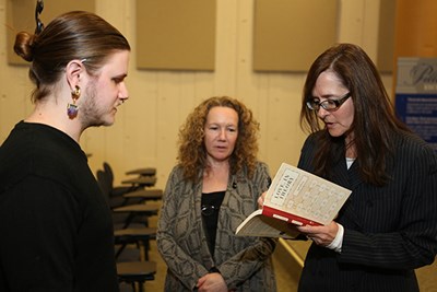 EJ Levy autographs a book for a student