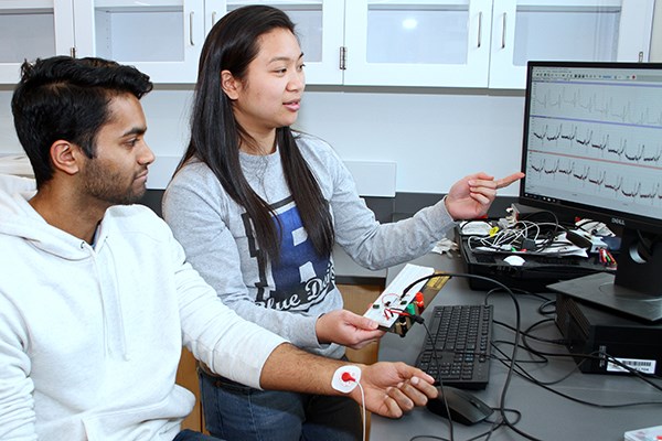Biomedical engineering students Herrick Fernandes and Meghan Fajarillo collect ECG data 