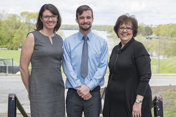 Liam Fouhy, center poses with professor Sabrina Noel Feldeisen, left, and Lawrence Senior Center Executive Director Martha Velez.
