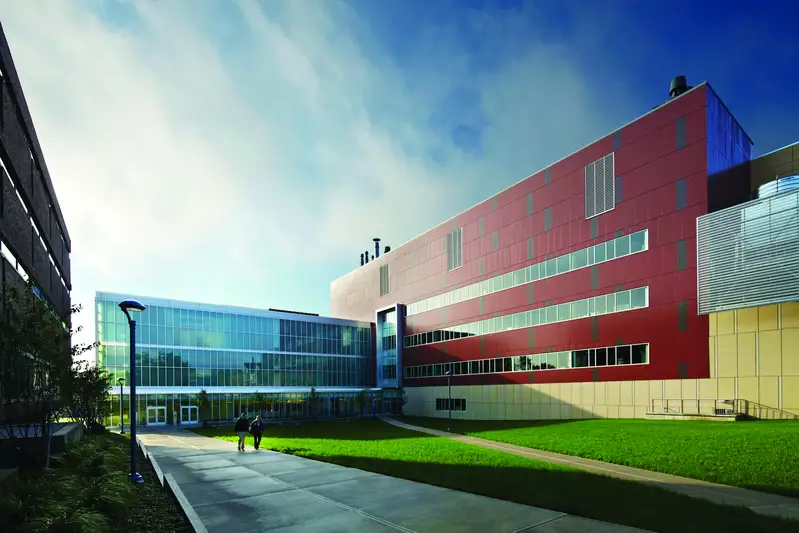 Two people walking on path at the Saab Emerging Technologies and Innovation Center