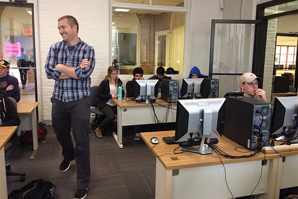 Asst. Prof. David Kingsley roams around during a lab session in Behavior Economics at UMass Lowell.