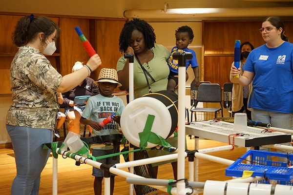Campers and UMass Lowell music studies students interact at the EcoSonic Playground camp for children with autism