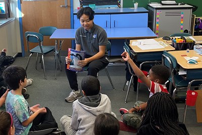 Lowell High School student Kaunitha Heng reads a book to third-graders at the Bailey School in Lowell