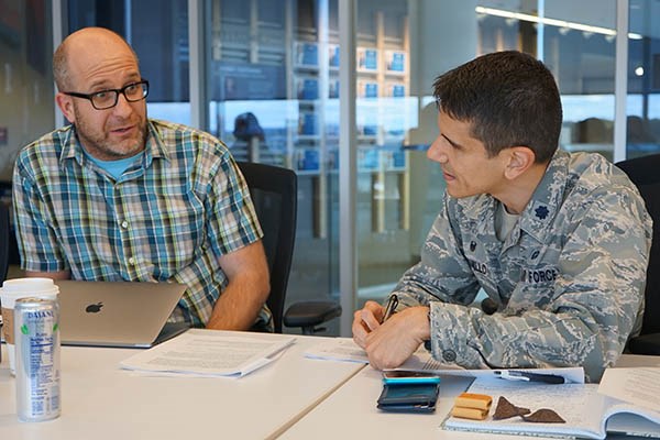 David Willis, associate chairman of mechanical engineering, chats with Lt. Col. Jesse Jaramillo, professor and commander of the Air Force ROTC program at UMass Lowell, during a faculty symposium on teaching methods.