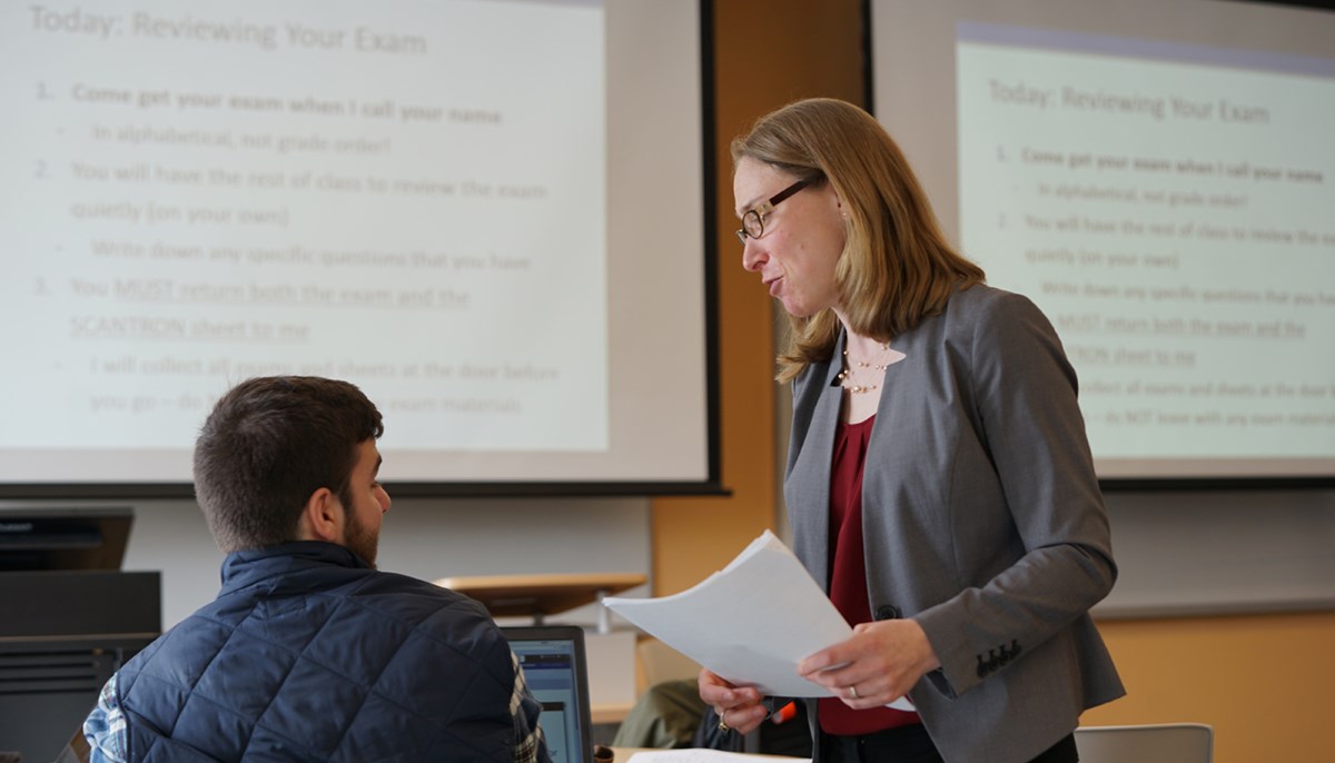 Assistant Professor Elana Feldman talks to a student in an organizational behavior course