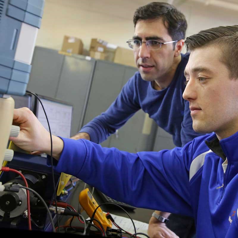 Student and professor at a computer in a UMass Lowell electrical and computer engineering lab