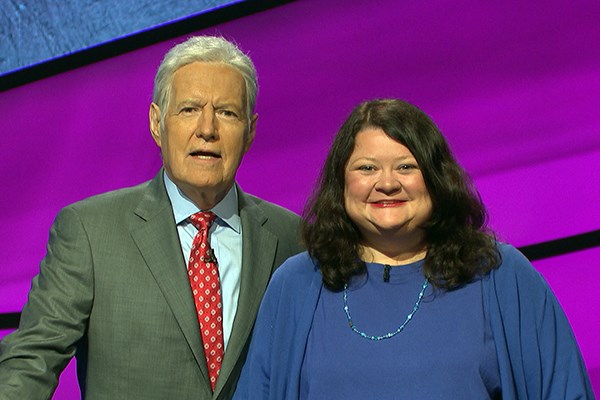 Librarian Ellen Keane poses with Jeopardy host Alex Trebek