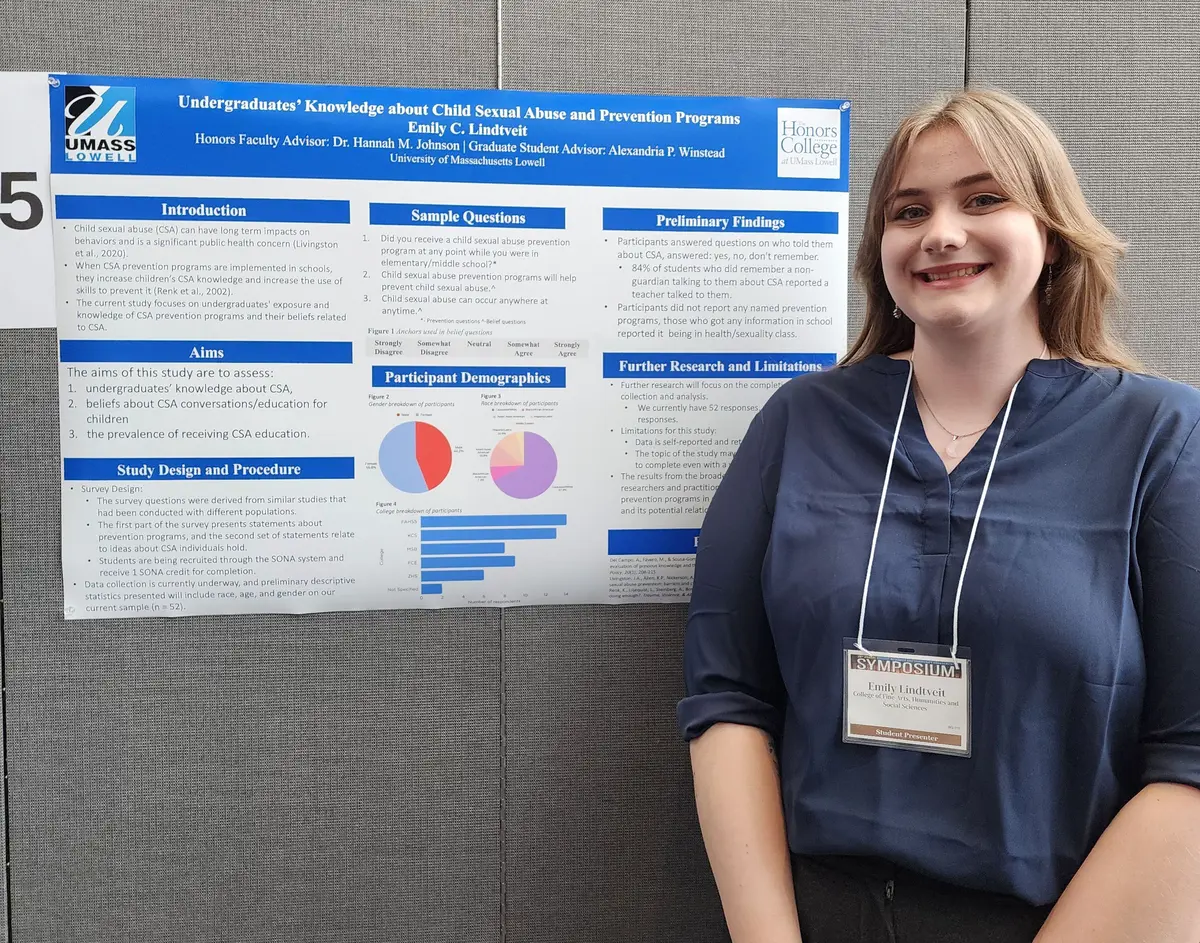 Emily Lindtveit in front of her poster