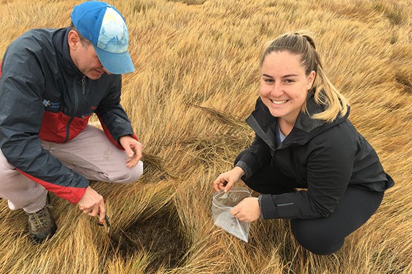 Student Emma Daly collects samples in field