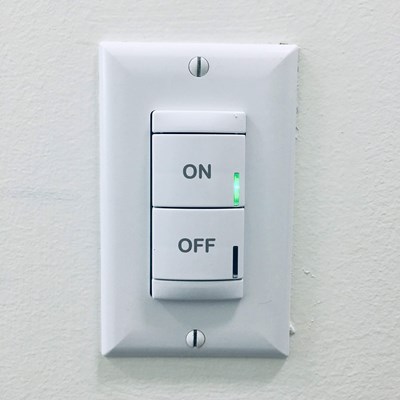 Energy-Energy Efficiency Projects: a white light switch on the wall programmed in "ON" mode.