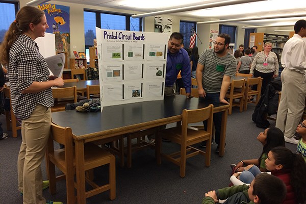Mechanical engineering students Courtney Britko, David Chhuon and Alli Ramadan explain printed circuit boards to fifth-graders at Sullivan Middle School.