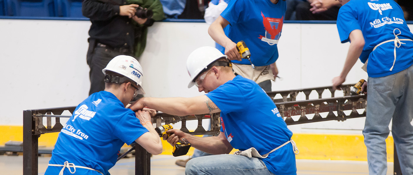 UMass Lowell students work on their team's Steel Bridge during the competition at the 2014 New England ASCE Student Conference.