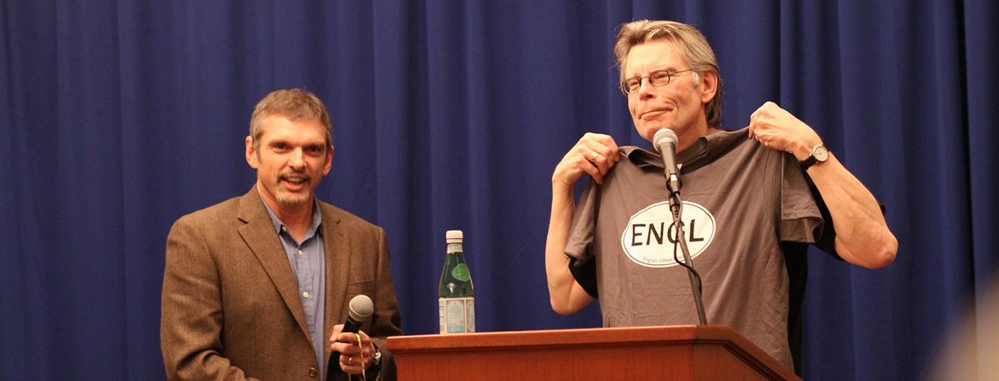 English Chair, Tony Szczesiul  presents author, Stephen King  with a t-shirt after speaking to UMass Lowell English students.