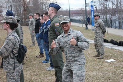 Man in uniform smiling giving two thumbs up.