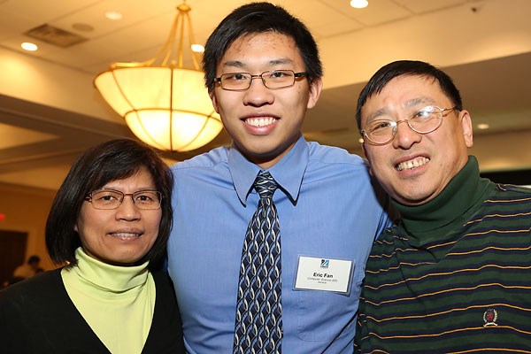 Student Eric Fan with his parents.