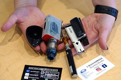 A student holds some of the collected vape pens