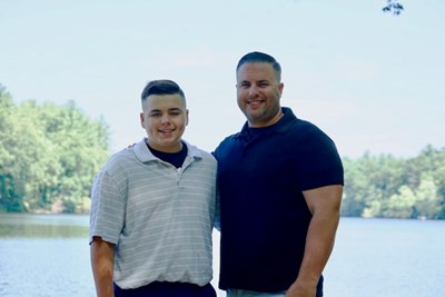 UMLPD Officer Brian Ethier and his son Colby standing by the Merrimack River