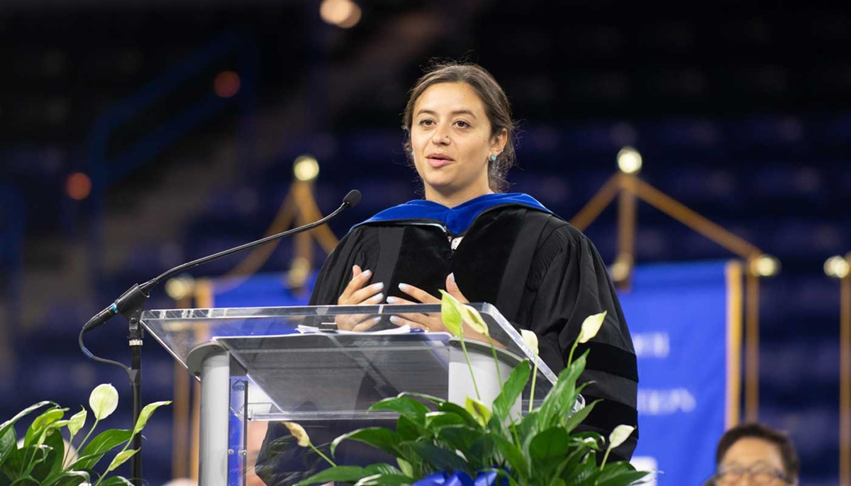 Evana Gizzi delivers a speech at the UMass Lowell graduation ceremony.