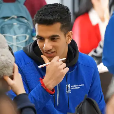 Student wearing a UMass Lowell Manning School of Business sweatshirt.