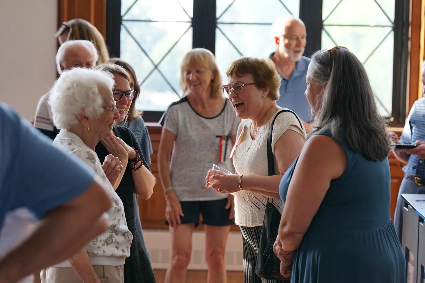 Suzanne Beebe laughs while talking with Doris Cote at the launch of the Greater Lowell Franco American Digital Archive