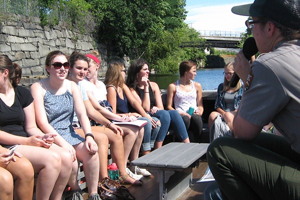 Students in the First-Year Seminar in Honors take a canal boat tour with a Lowell National Historical Park ranger