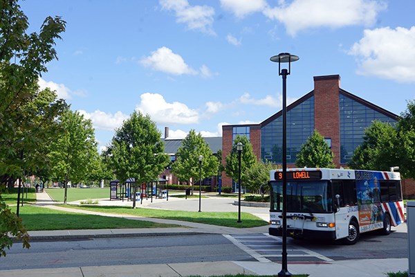 A city bus leaves the traffic circle in front of the Campus Rec Center
