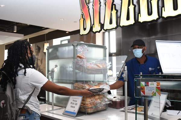 A student picks up food at the Fox Dining Commons