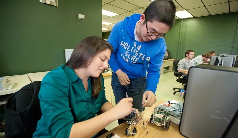 Electrical and computer engineering students building robots