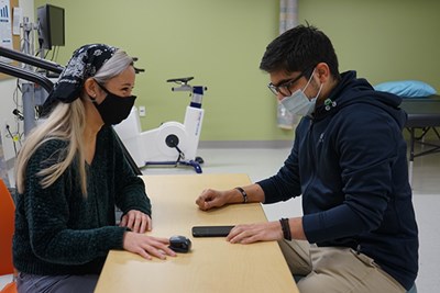 Andreas Himariotis, right, checks Stephanie Amico's heart rate in the Health Assessment Lab