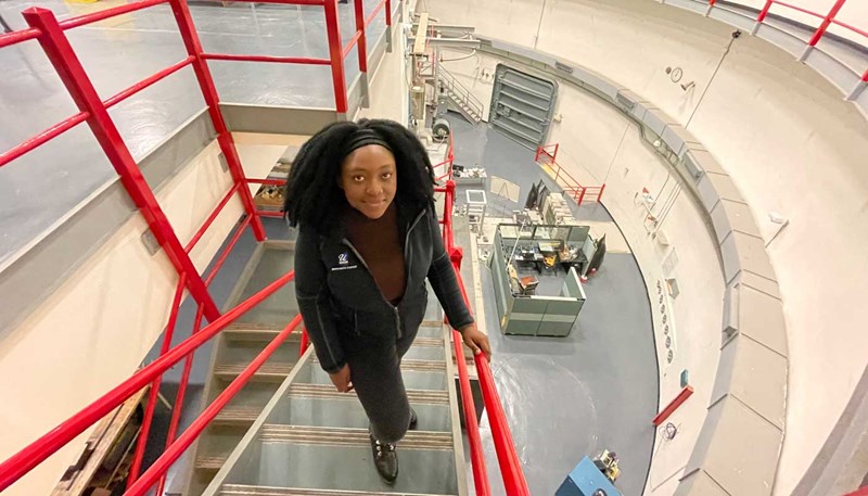 Francesca Kamwa on a spiral staircase in the nuclear reactor at UMass Lowell
