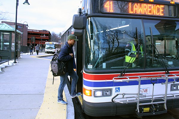 Ramses Jimenez boards an MVRTA bus in Lowell