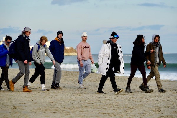 Garret Roberts walks with friends on Hampton Beach