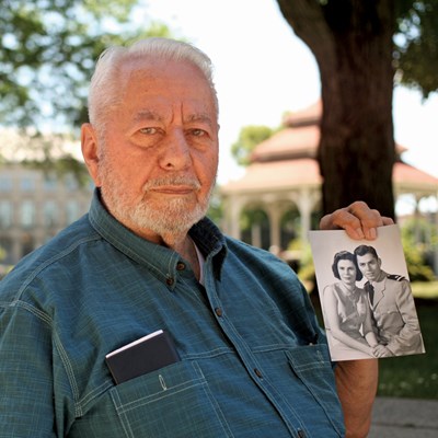 George Scagos holding photo of him and his wife