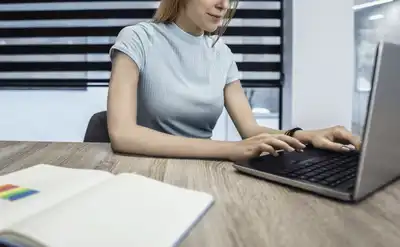 Confident Creative business person working on laptop at their workplace at a modern office.