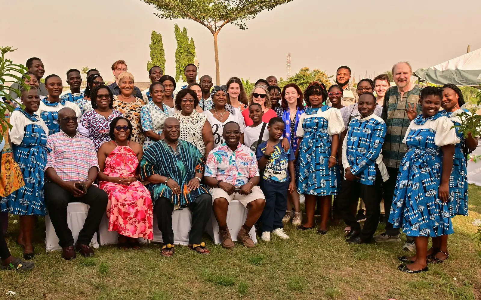 Group photo of dozens of members of Ghana community and their UMass Lowell visitors
