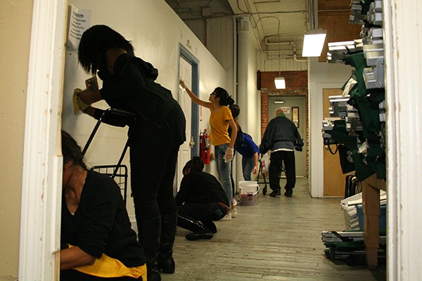 Grad students clean walls at the Lowell Transitional Living Center