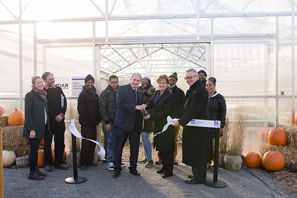 Chancellor Jacquie Moloney and guests cut the ribbon on the greenhouse