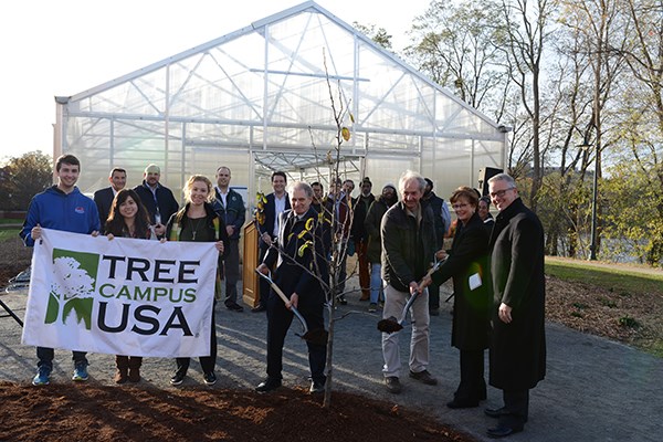 An Asian pear tree is planted in a ceremony at the greenhouse 