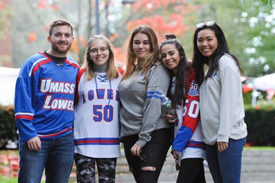 Group of students in River Hawk Hockey Jersey's outside at the Engagement Fair