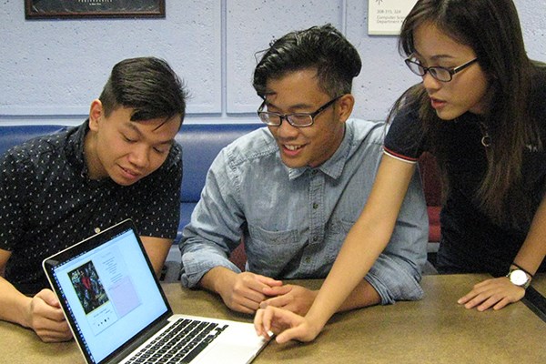 Computer science students Kody Thach, Cullin Lam and Huong Nguyen demonstrate the app they created at the Shark Hack.