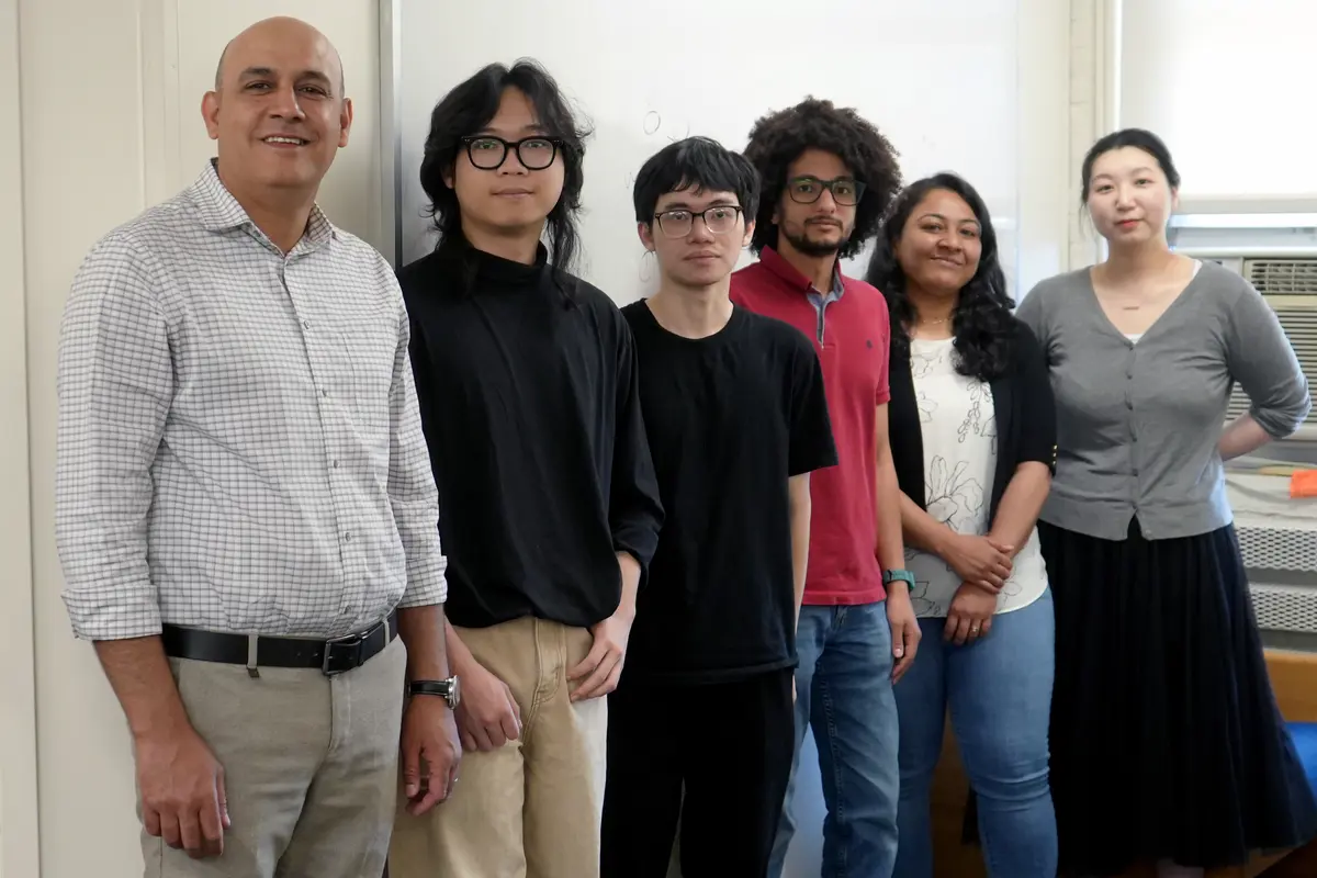 Hadi Amiri stands with five student researchers.