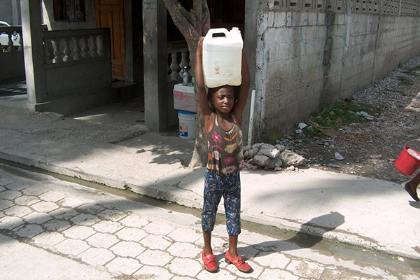 A girl carrying water in Haiti.