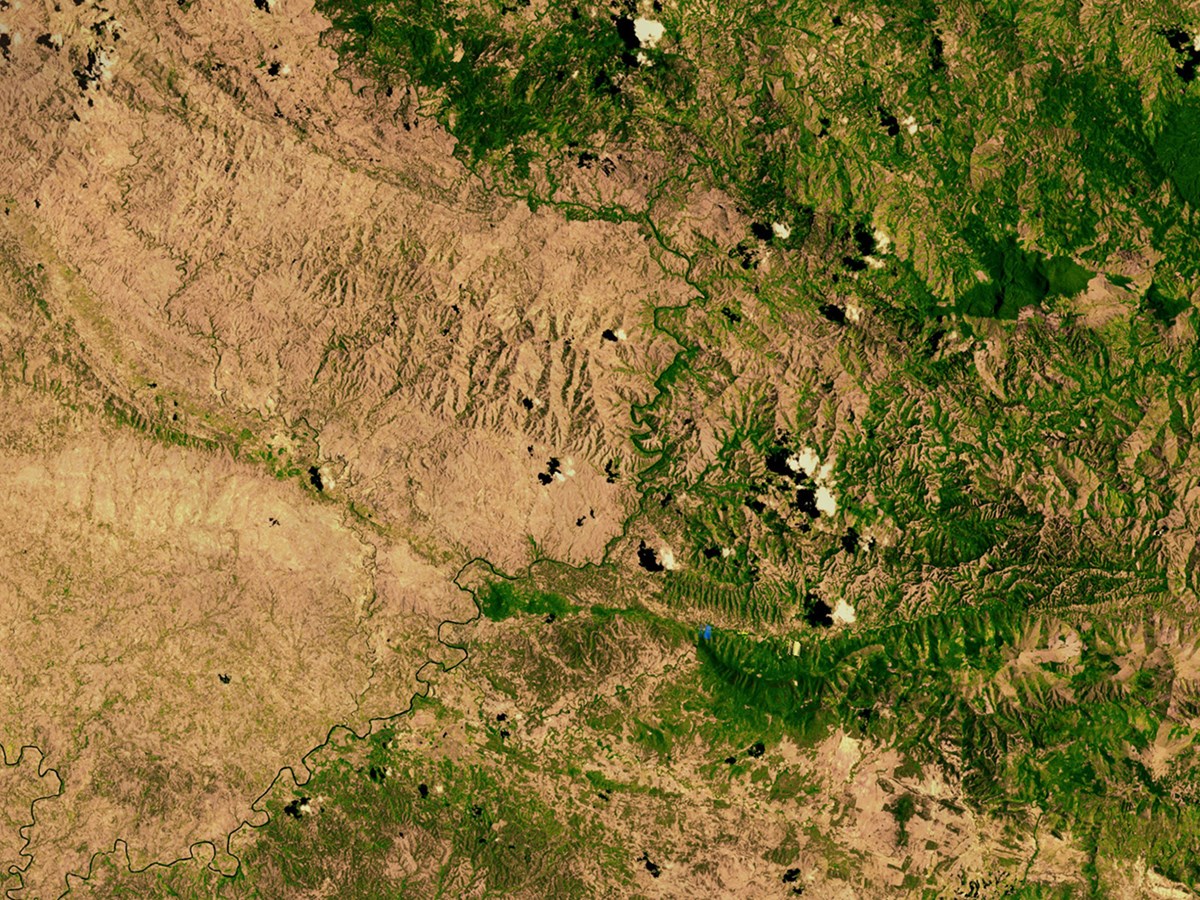 A NASA satellite image of the border between the denuded landscape of Haiti (left) and the Dominican Republic (right).