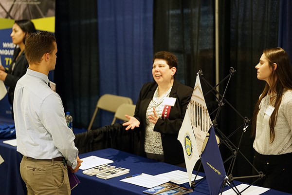Alum Cheryl Medina talks to a student about working at the Dept. of Treasury