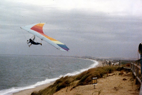 A student sails off the dunes at Cape Cod