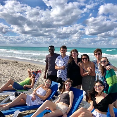 Havana Cuba full group photo of students lounging on beach chairs and standing in Winter 2019-2020.
